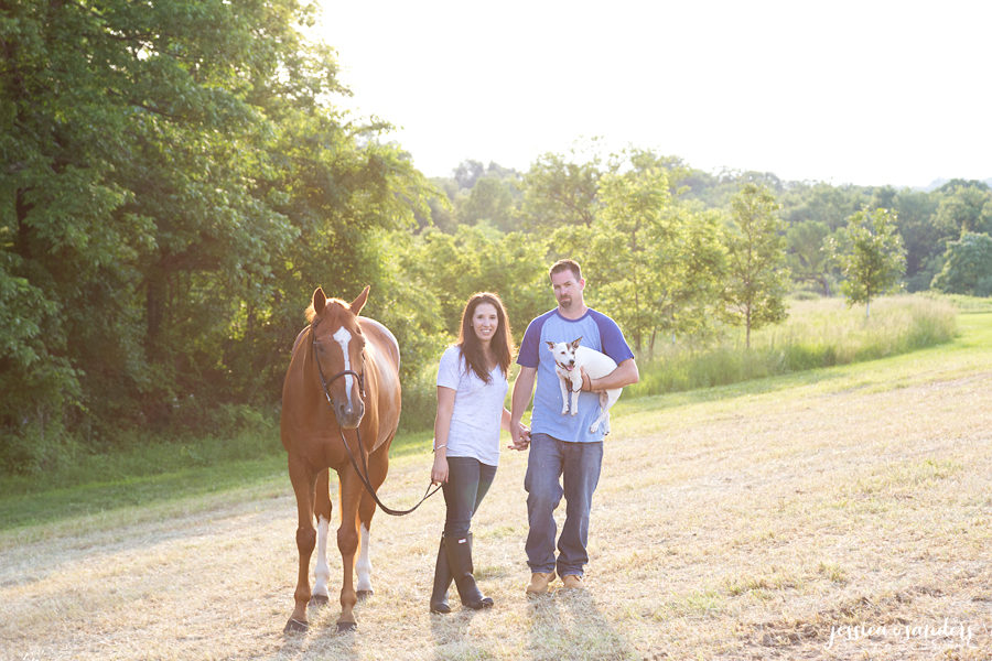 married couple at Christie Hoffman Farm Park at sunset with their dog and horse
