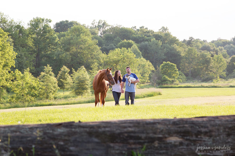 married couple walking with their dog and horse at Christie Hoffman Farm Park