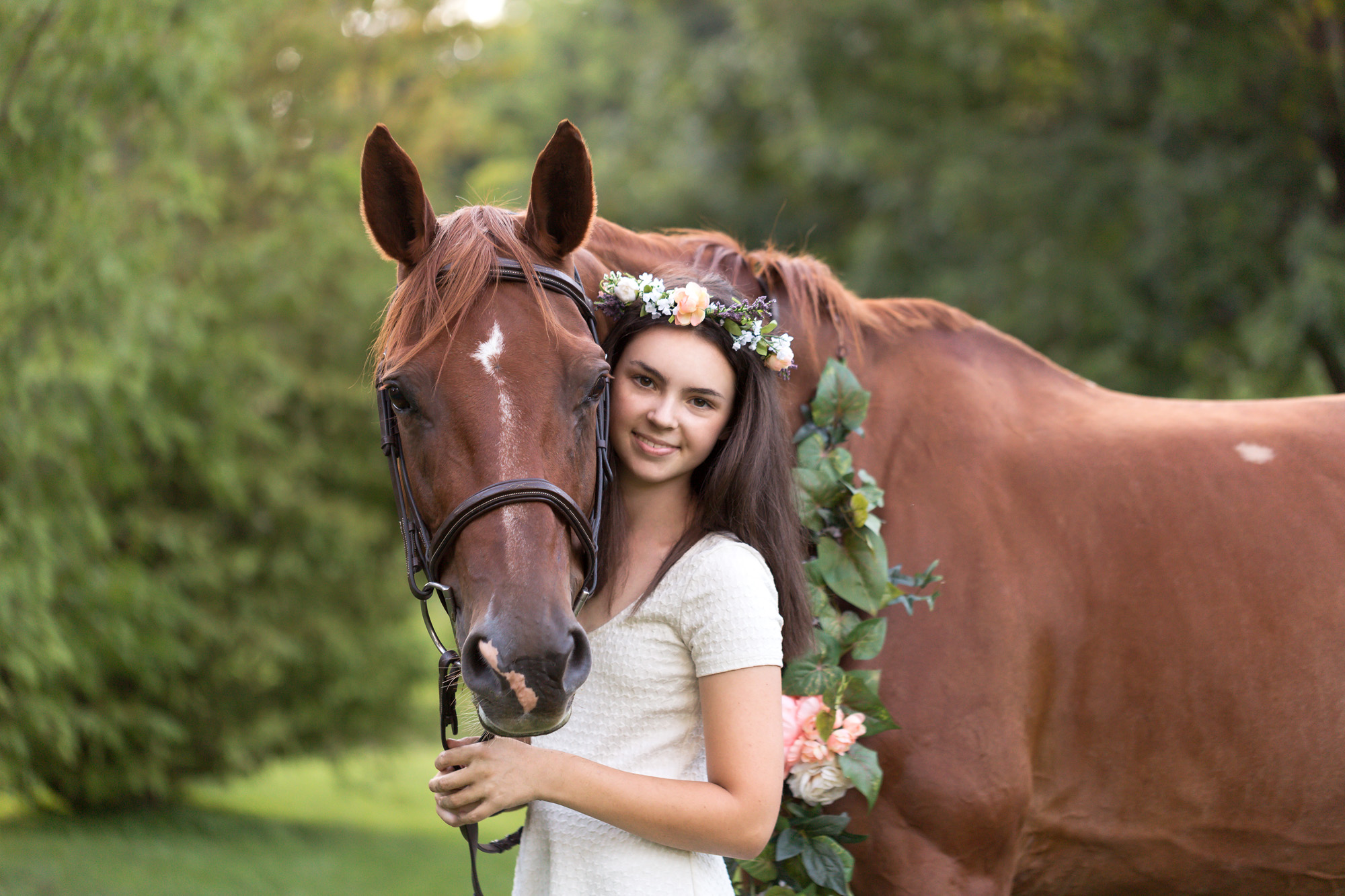 teenage girl with flower crown with a chestnut mare Warmblood horse with flowers