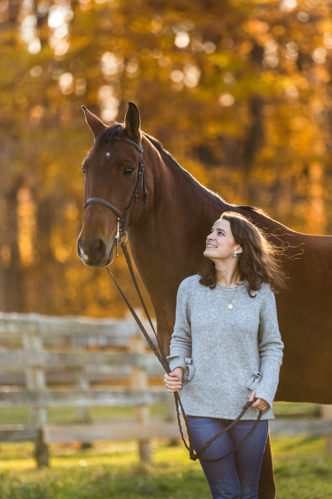 girl in grey sweater with horse