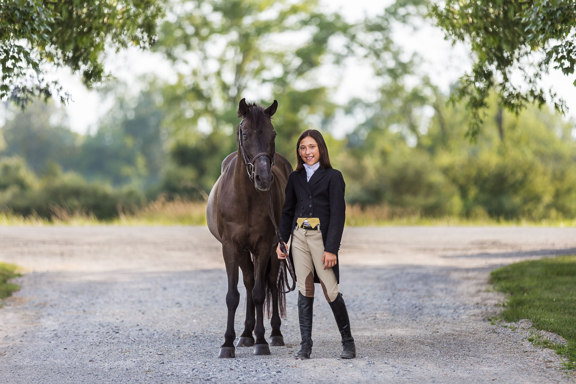 little girl in show clothes holding bay pony