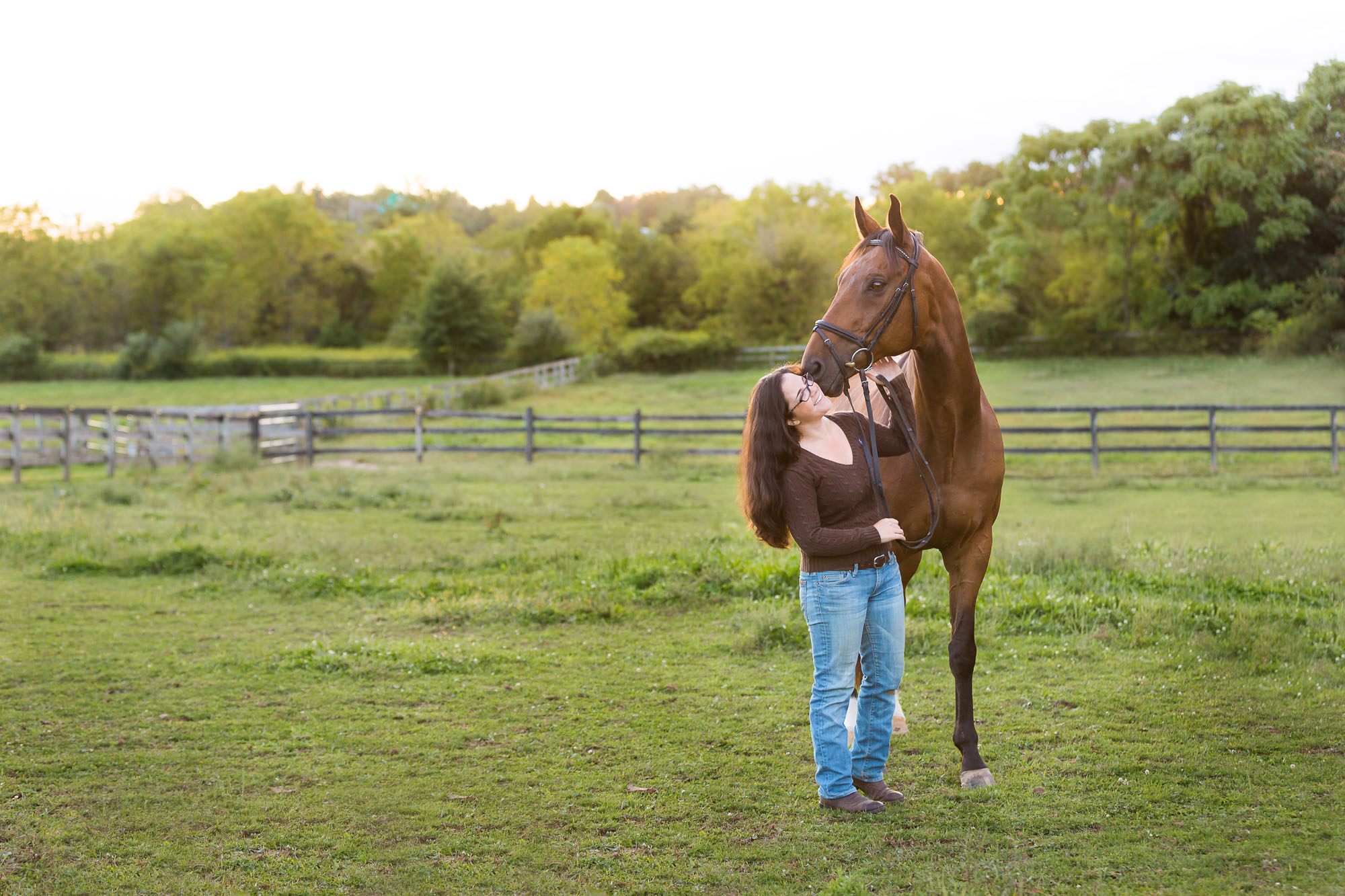 girl and horse in grassy field
