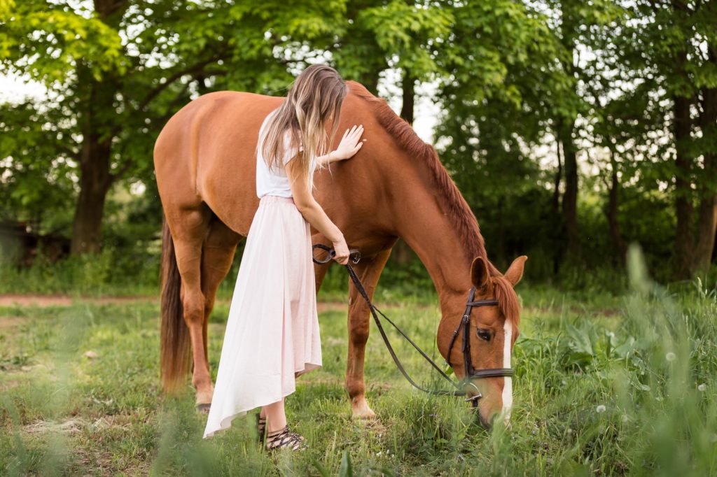 girl in pink skirt grazing her horse at Magnolia Creek Stables
