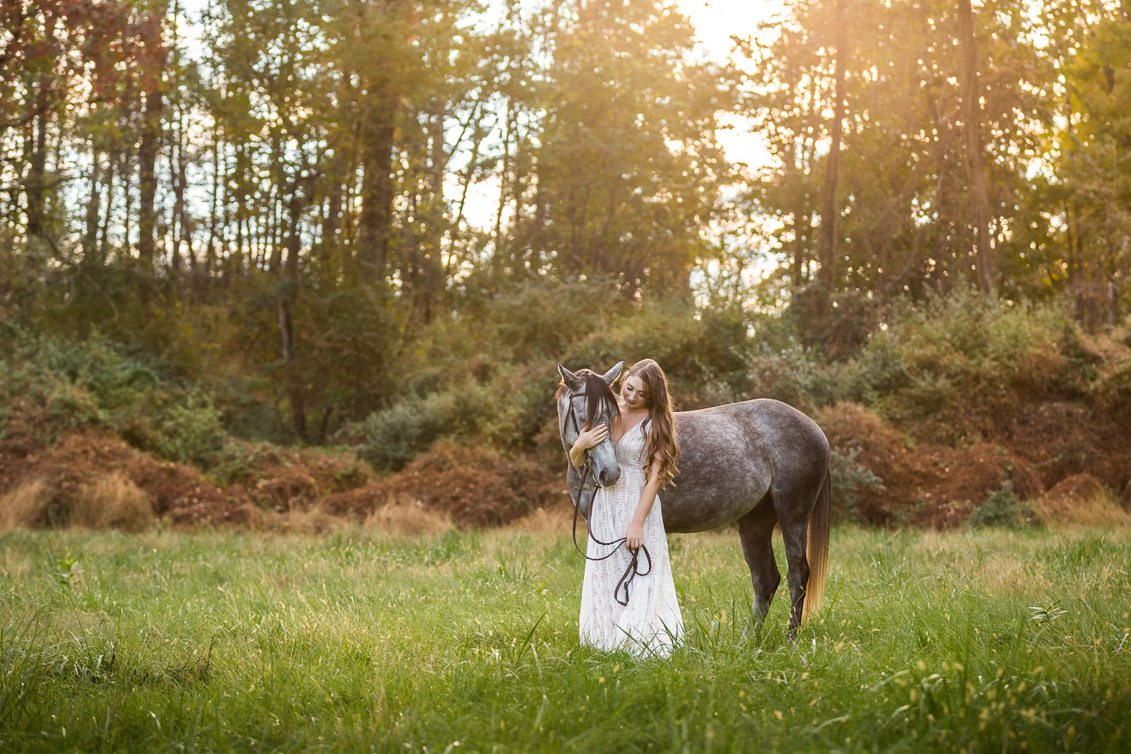 girl in white dress with dappled grey horse