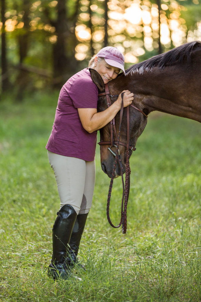 woman hugging the head of her bay mare at Ponyz on the Rockz