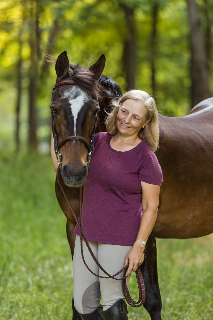 woman in mauve top with her bay mare at Ponyz on the Rockz