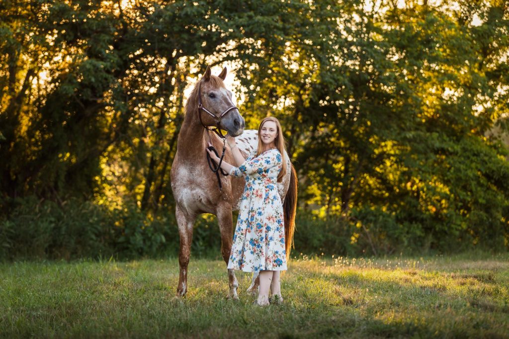 girl with appaloosa horse in field at Tri-Brook Equestrian Center