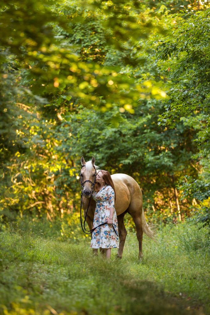 girl with palomino horse in the woods at Tri-Brook Equestrian Center in New Egypt, NJ