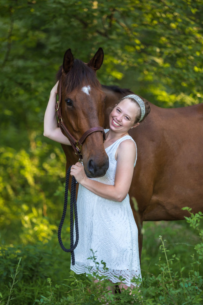 girl with OTTB in the woods