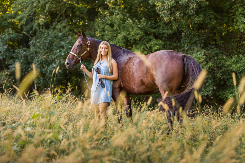woman in blue dress with dappled mare at Voight Farm