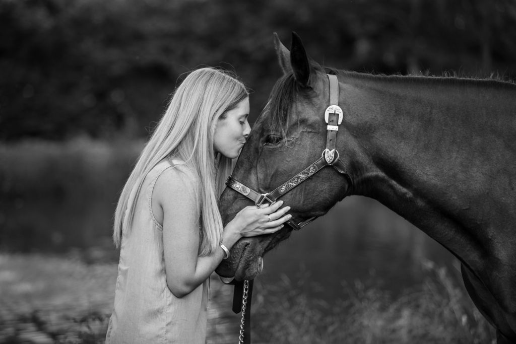woman kissing bay horse