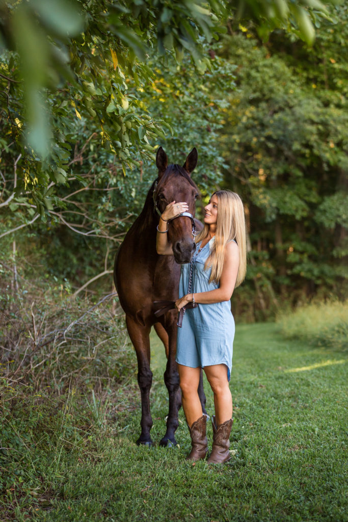woman in blue dress holding standarbred at Voight Farm