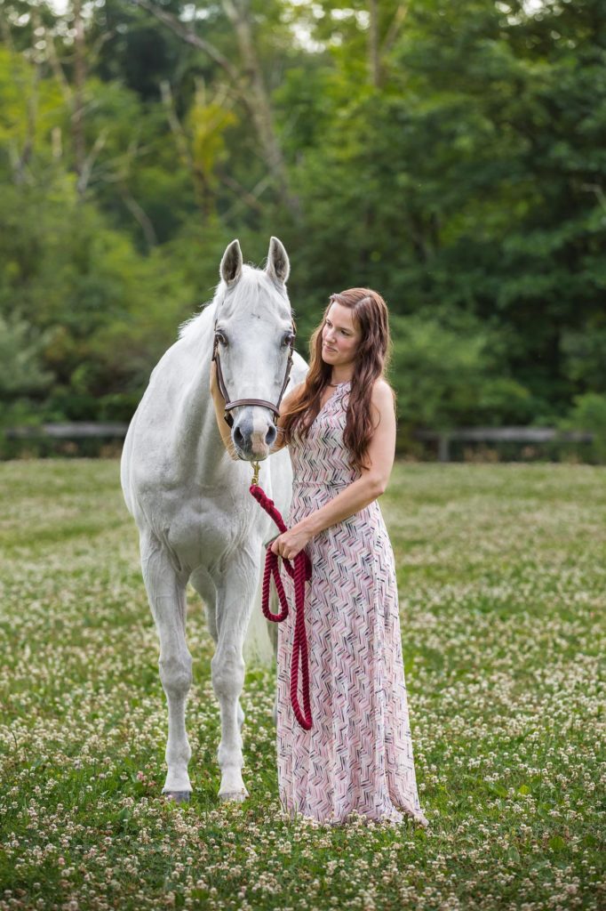 girl in pink dress with white horse at Duck Crossing Farm