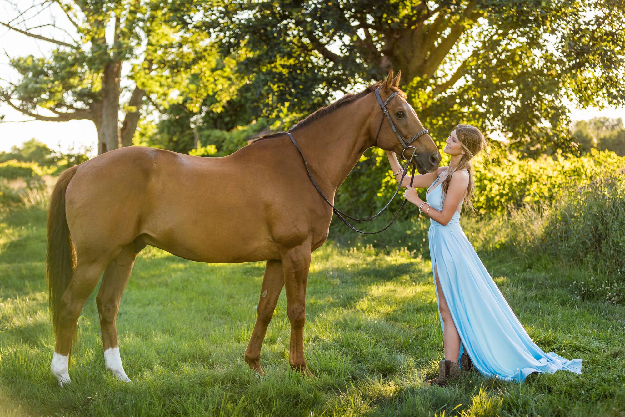 Alyssa in a long blue dress with Ben at Cambria Stables